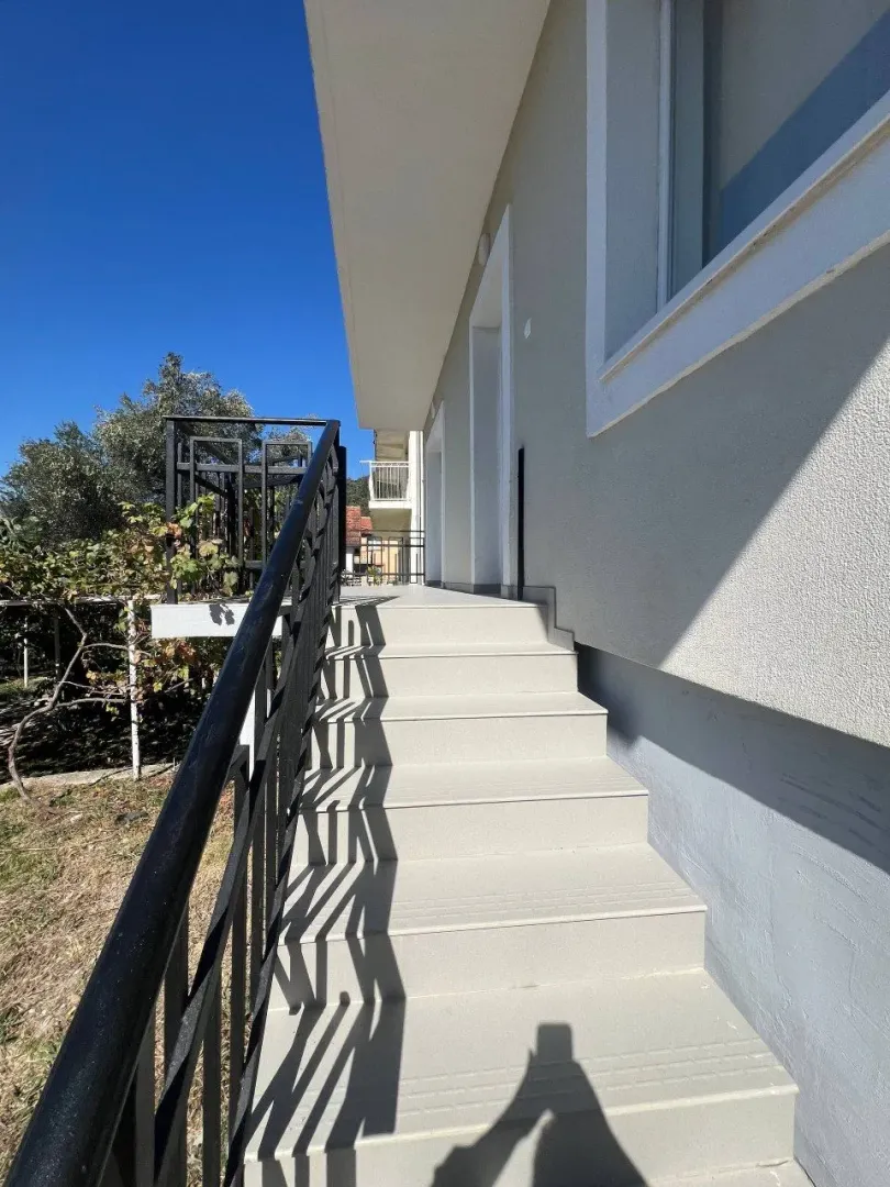 Exterior stairs with a railing leading to the house entrance.