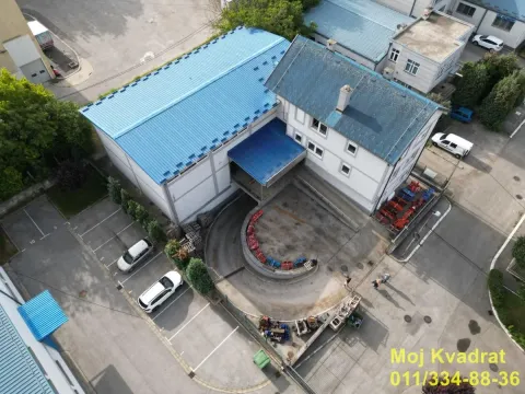 Aerial view of a commercial building with adjacent parking space. - image 17