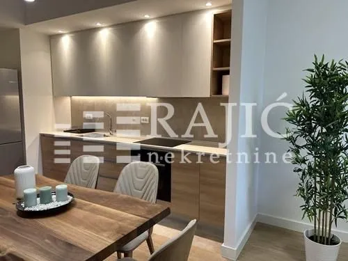 Modern kitchen with a dining area and built-in units.