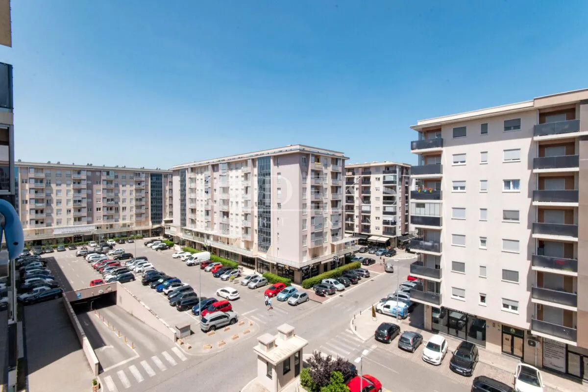 View from the terrace overlooking residential buildings and the parking lot in front of the property.