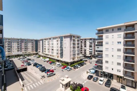 View from the terrace overlooking residential buildings and the parking lot in front of the property. - image 11