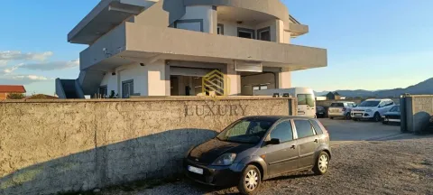 Exterior of a multi-story house with a yard and parked cars. - image 2