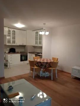 Kitchen with dining area and white cabinets. - image 3