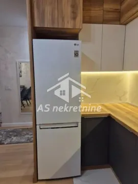 Modern kitchen with fitted units and a white refrigerator. - image 14