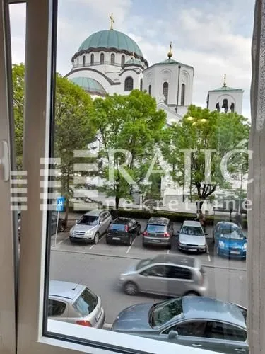 View through the window of a temple and parking lot.