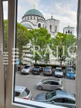 View through the window of a temple and parking lot. - image 12