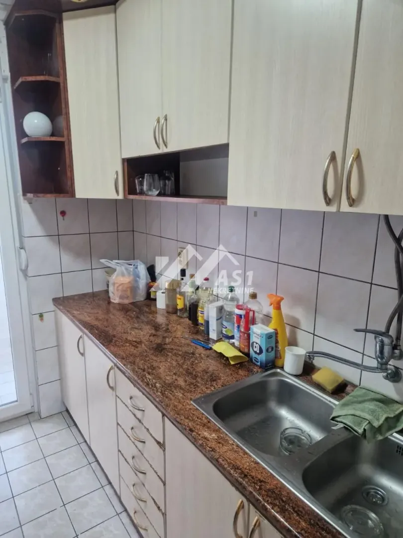 Smaller kitchen with a sink, countertop, and wall cabinets.