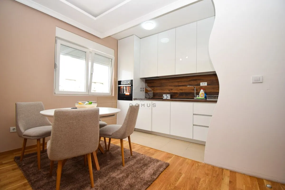 Kitchen with dining area and white cabinets.