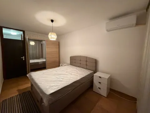 Furnished bedroom with a double bed, wardrobe, and air conditioning. - image 8