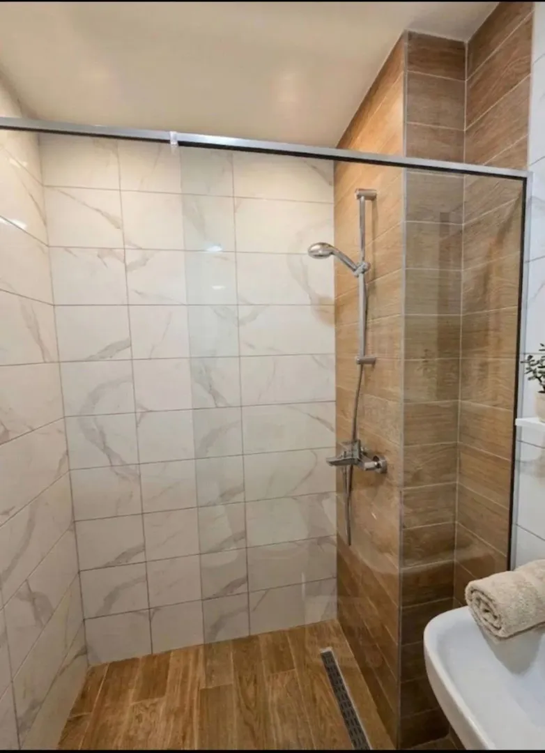 Modernly equipped bathroom with a walk-in shower.