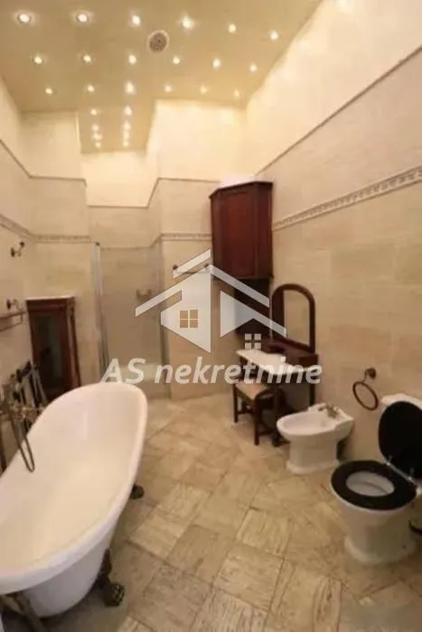 Spacious bathroom with a bathtub, shower enclosure, and sanitary ware.