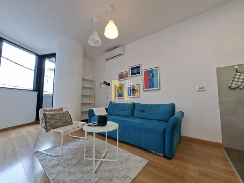 Living room with a blue sofa, armchair and coffee table. - image 19