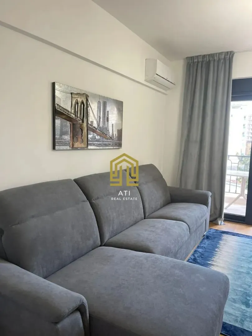 Living room with a sofa and access to the terrace.