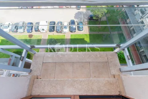 View from the balcony overlooking the parking lot and building courtyard. - image 7