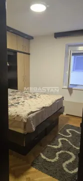 Bedroom with a double bed, wardrobe, and a window. - image 4