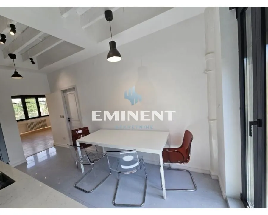 Dining area with a white table and chairs in a modern interior.
