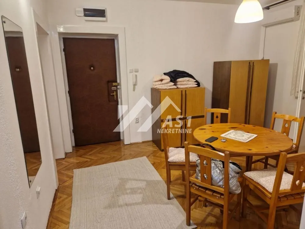 Living room with a dining table and wooden furniture.