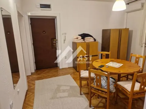 Living room with a dining table and wooden furniture. - image 5