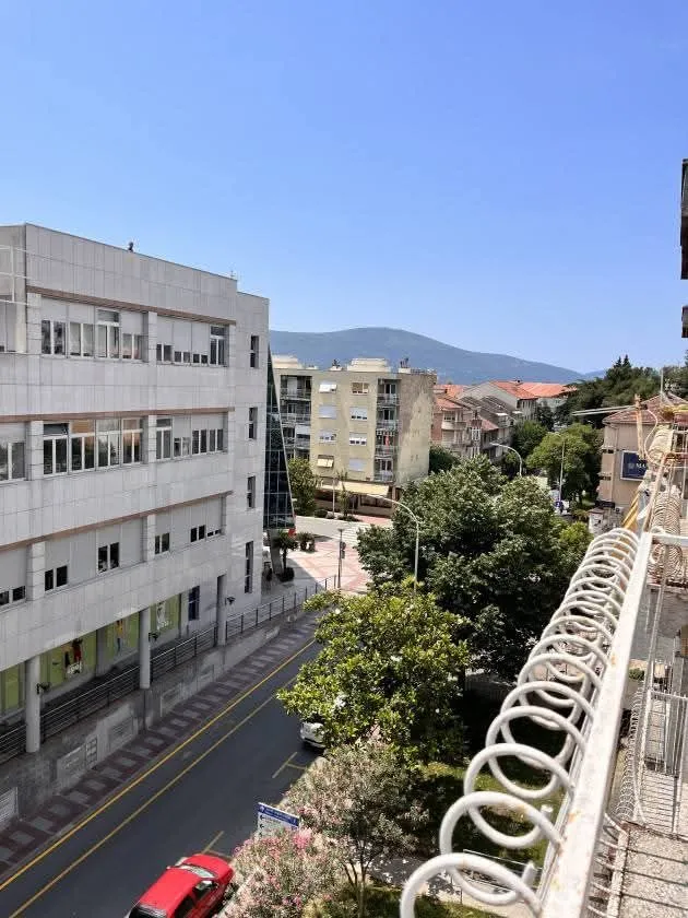 View from the terrace overlooking the city street and surrounding buildings.