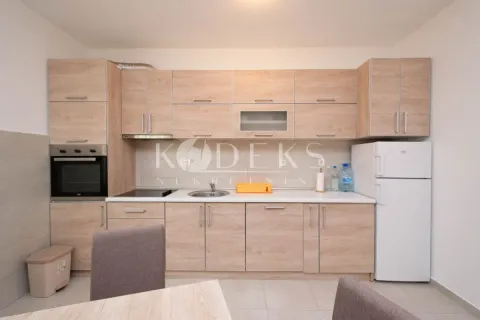 Kitchen equipped with wooden cabinetry and white goods. - image 4