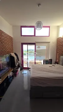 Bedroom with a double bed, high ceiling, and access to a terrace overlooking the pool. - image 16