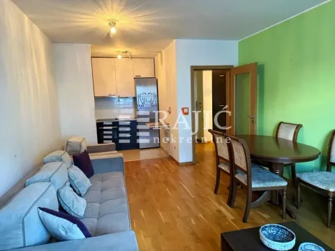 Living room with dining area and kitchen in the background. - image 11