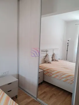 Bedroom with a double bed and a large built-in wardrobe with a mirror. - image 4