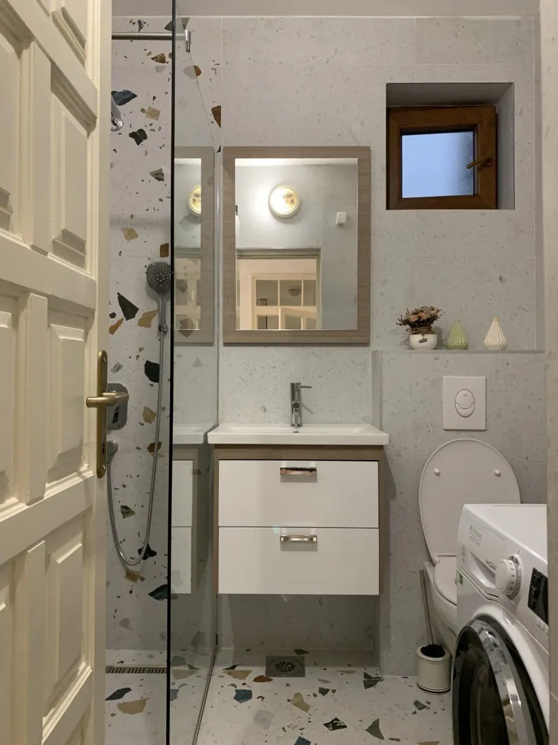 Modern bathroom with a vanity and washing machine.
