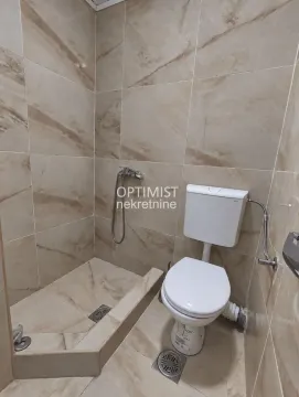 Manje kupatilo obloženo keramičkim pločicama sa tuš-kabinom i wc šoljom. - image 13