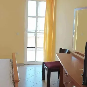 Furnished bedroom with a bed, desk, and access to the terrace. - image 4