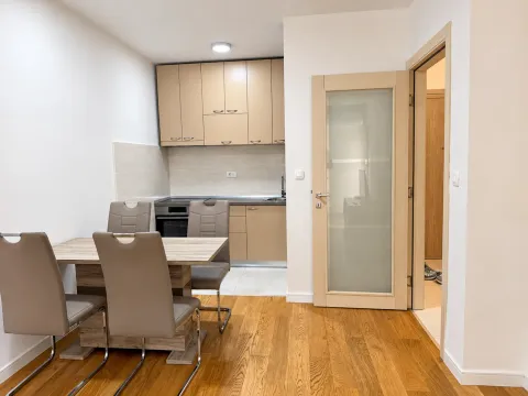 Kitchen with a dining table and chairs, and wooden flooring. - image 5