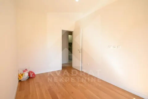 Empty room with wooden flooring and an open door. - image 11