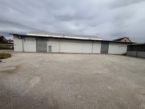Exterior view of an industrial building with a large paved courtyard. - image 2