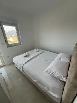 Bright bedroom with a double bed and a window. - image 6