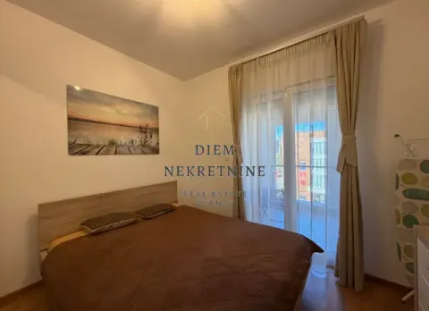 Furnished bedroom with a double bed and balcony access. - image 8