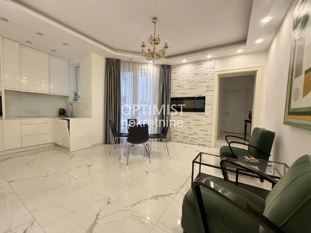 Living room with dining area and kitchen in an open plan space.