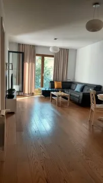 Living room with a sofa, wooden floor and access to the terrace. - image 17