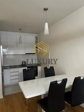 Small kitchen with a dining table and black chairs. - image 3