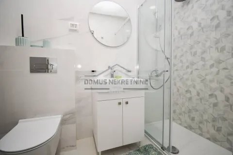 Savremeno opremljeno kupatilo sa tuš kabinom, umivaonikom i WC šoljom. - image 10