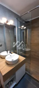 Modern bathroom with a washbasin on a wooden vanity and a glass shower cabin. - image 9