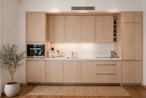 Moderna kuhinja sa elementima od svijetlog drveta i ugrađenim aparatima. - image 4