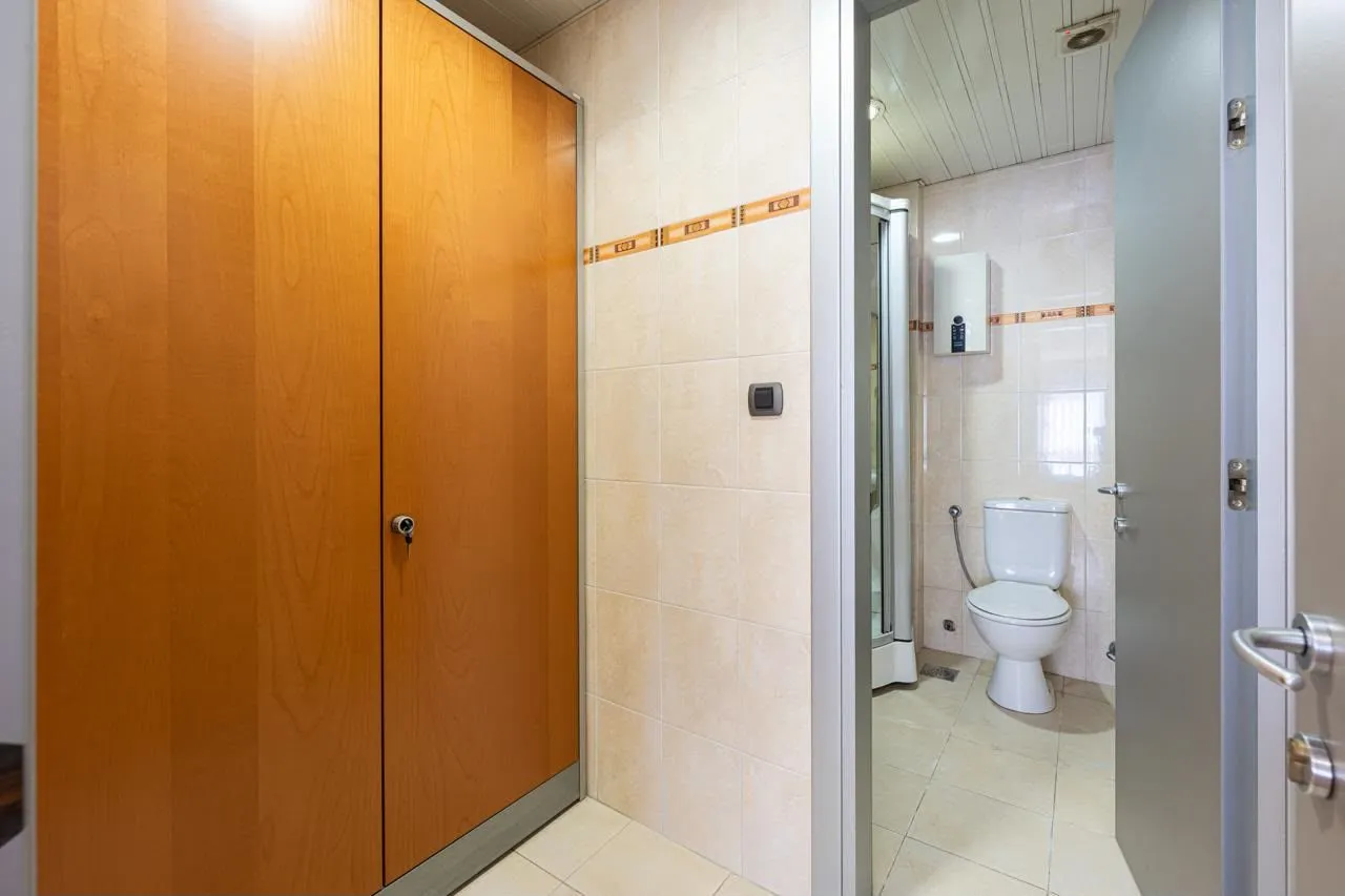 View of the bathroom with a toilet and shower cabin.