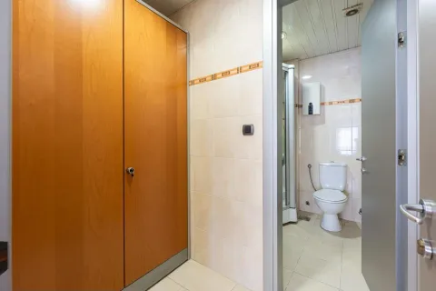View of the bathroom with a toilet and shower cabin. - image 15