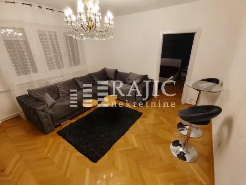 Living room with a sofa and parquet flooring. - image 2