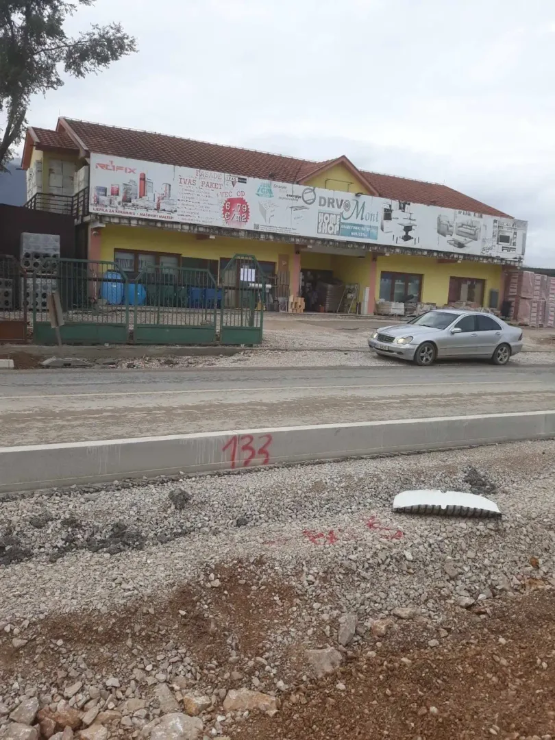 Exterior view of a commercial building next to a road under construction.