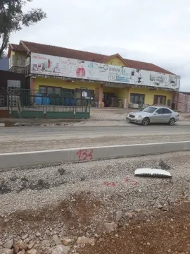 Exterior view of a commercial building next to a road under construction. - image 4
