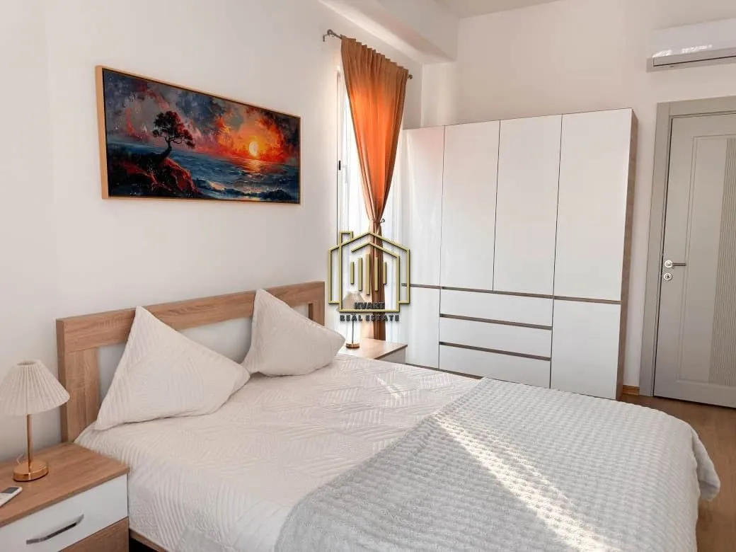Master bedroom with a double bed, wardrobe, and wall art.