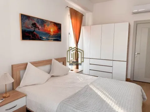 Master bedroom with a double bed, wardrobe, and wall art. - image 6