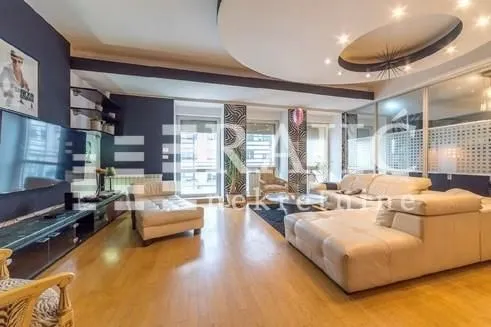 Spacious and bright living room with a sofa set and modern ceiling design.
