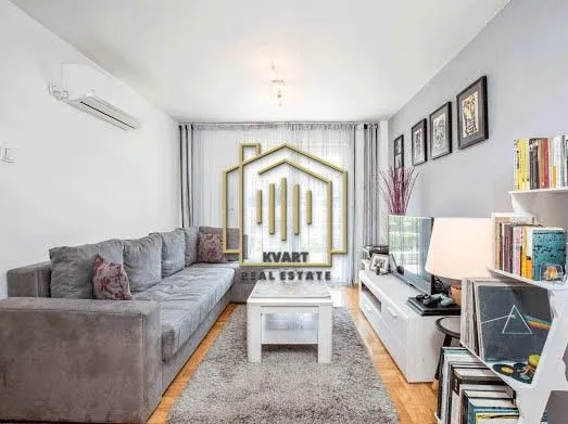 Living room with sofa, coffee table, and television.